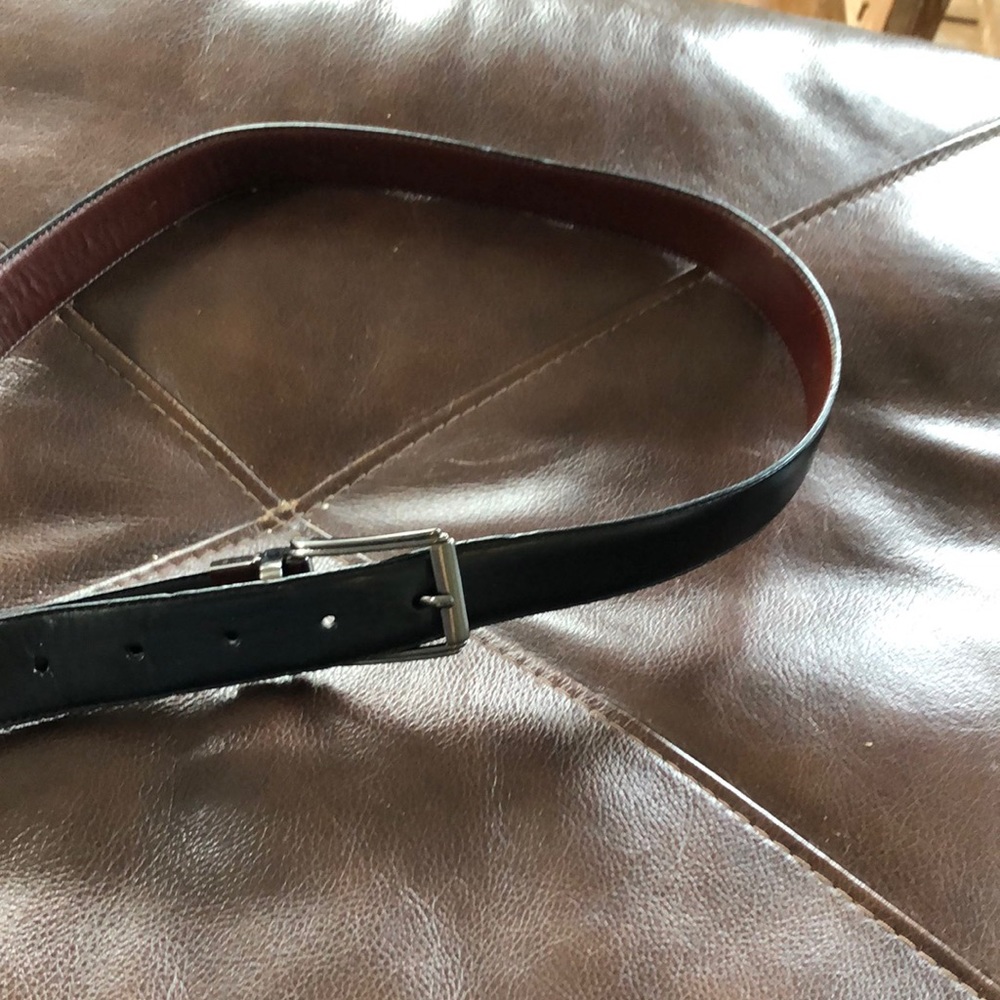Men’s black belt with silver buckle. Size 38.